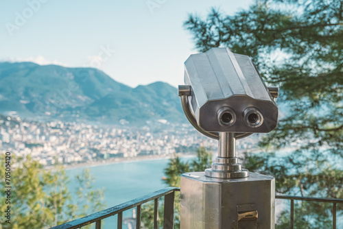 Vandal-proof stationary binoculars with a coin acceptor in a tourist place on an observation deck overlooking the sea coast. Tourist infrastructure, a place to view the landscape from above.