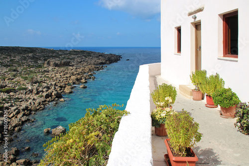 mediterranean sea and commons (habitation building ?) in an orthodox monastery (chrysoskalitissas) in crete in greece