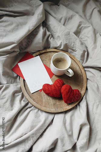 Valentines day, 14th Februray concept. Breakfast in bed. Cup of coffee and red hearts. Bedroom composition. blank greeting card, invitation mockup. Wedding, love concept. Flat lay, top view, vertical.