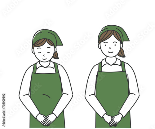 お辞儀をするエプロン姿の女性店員
