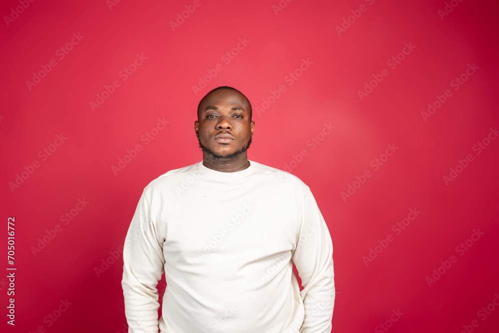 Young man isolated on red background sad, serious face, feeling miserable and displeased. Young man isolated on red background sad, serious face, feeling miserable and displeased.