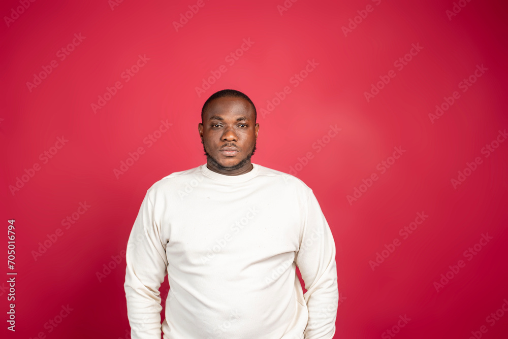 Young man isolated on red background sad, serious face, feeling miserable and displeased. Young man isolated on red background sad, serious face, feeling miserable and displeased.
