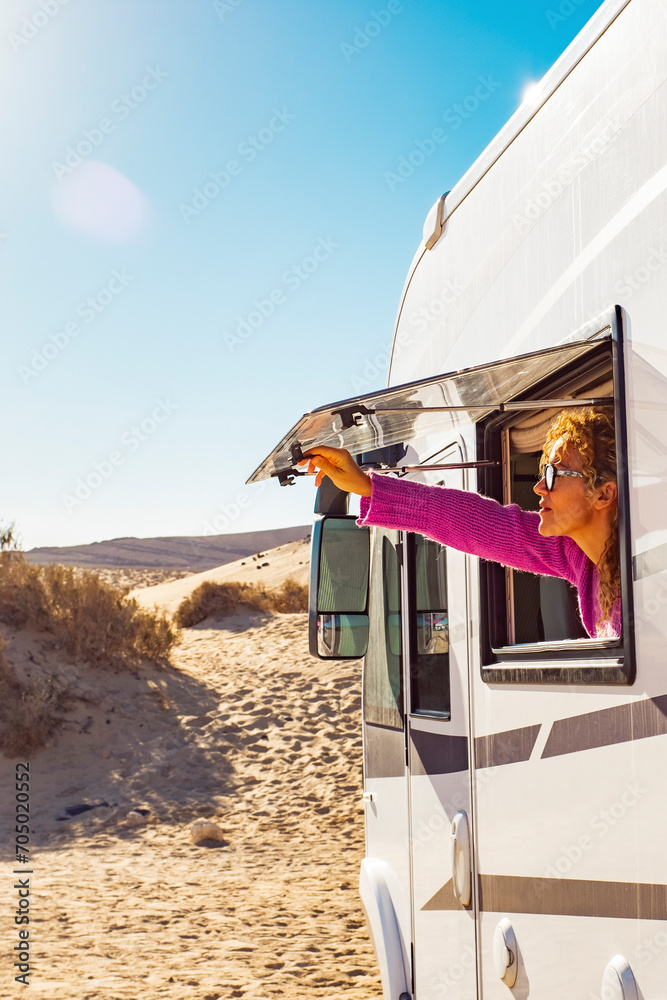 Φωτογραφία Adult tourist woman opening camper van window to enjoy the sun and freedom