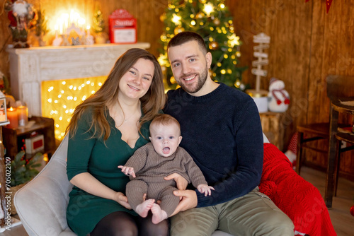 Cute newborn child, baby boy, with mom and dad on Christmas © Tomsickova