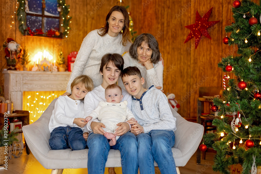 Happy family, newborn baby and older brothers, mom at home on Christmas