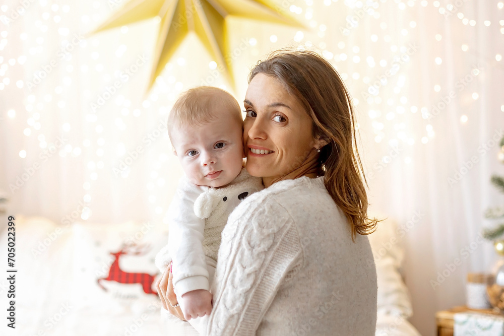 Happy family, newborn baby and older brothers, mom at home on Christmas Happy family, newborn baby and older brothers, mom at home on Christmas