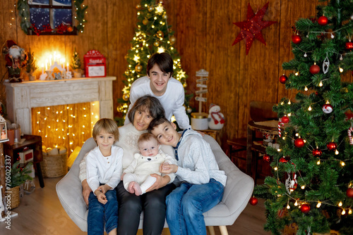 Happy family, newborn baby and older brothers, mom at home on Christmas © Tomsickova