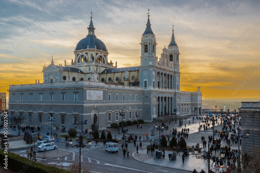 Madrid, Spain 28-12-2022 The Almudena Cathedral during a colorful sunset, it is the most important  and Catholic religious building in Madrid and a visit is free of charge except for the crypt   - obrazy, fototapety, plakaty 