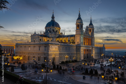 Fototapeta Naklejka Na Ścianę i Meble -  Madrid, Spain 28-12-2022 The Almudena Cathedral during a colorful sunset, it is the most important  and Catholic religious building in Madrid and a visit is free of charge except for the crypt  