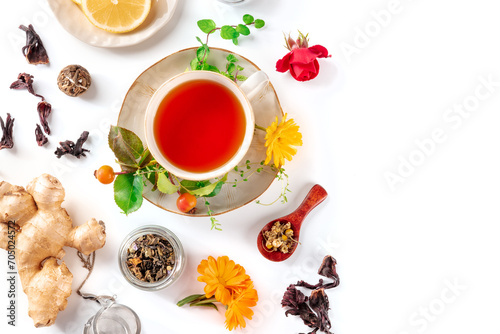 Tea with various ingredients and a place for text. Herbs, fruits, and flowers, overhead flat lay shot on a white background. Healthy natural remedies