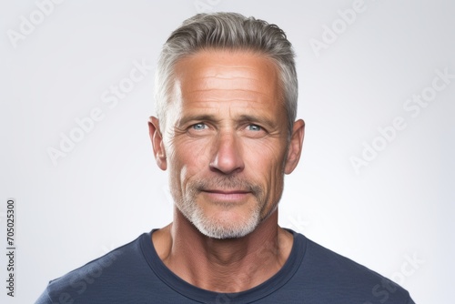 Portrait of mature man with grey hair and beard. Studio shot.