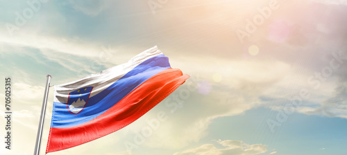 Slovenia national flag cloth fabric waving on the sky - Image