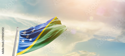 Solomon Islands national flag cloth fabric waving on the sky - Image