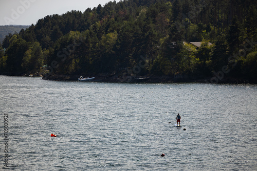 A paddle boarder in Iskar Reservoir Bulgaria. Beautiful nature. Person on the water beneath the mountains.