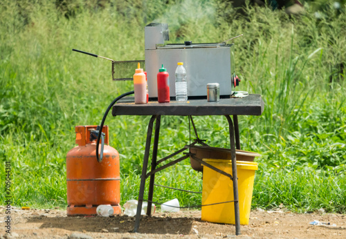 fast food fat fryer on a metal table on the side of the road showing informal small business in South Africa concept informal trading