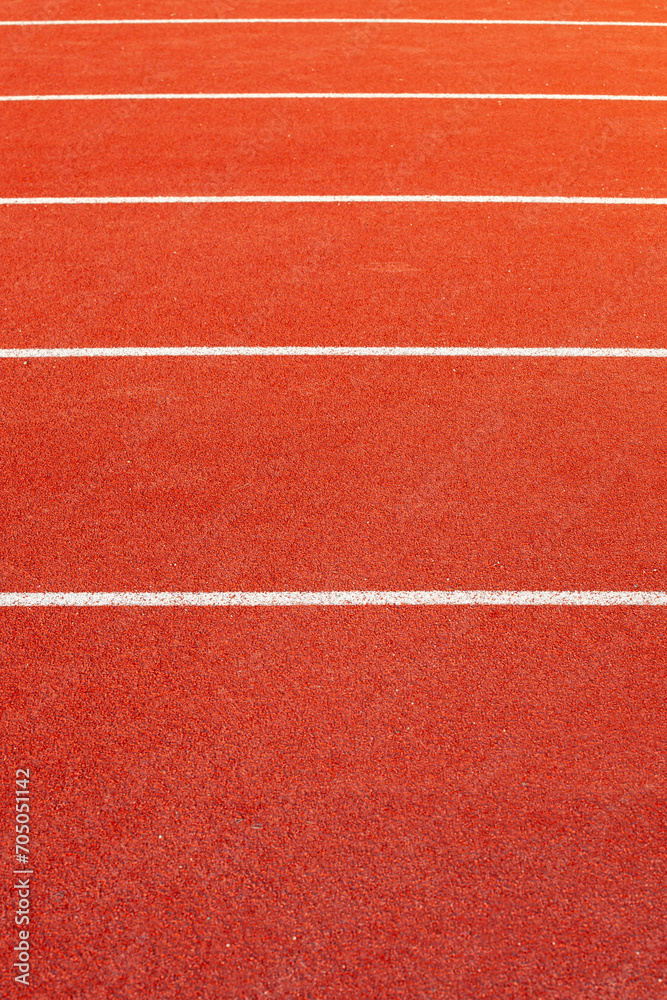 Red athletic  running track in stadium. Rubber coating.
