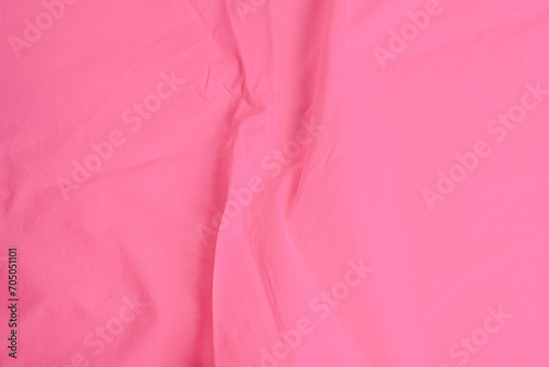 Smooth elegant pink sheet with creases as background with copy space