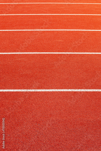 Red athletic running track in stadium. Rubber coating.
