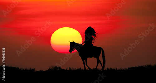 silhouette of indians man riding a horse on sunset background © K.Pornsatid
