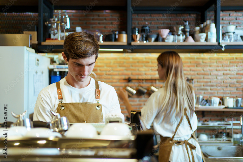 Professional caucasian coffee barista making a cup of coffee by using a modern espresso machine. Barista serving a cup of coffee to female customer over the coffee bar. Professional caucasian coffee barista making a cup of coffee by using a modern espresso machine. Barista serving a cup of coffee to female customer over the coffee bar.