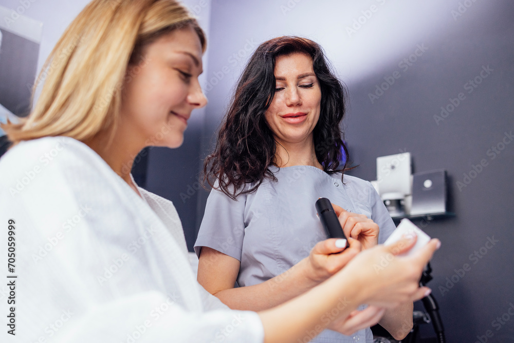 Pretty caucasian beautician communicates with her female client. Pretty caucasian beautician communicates with her female client.