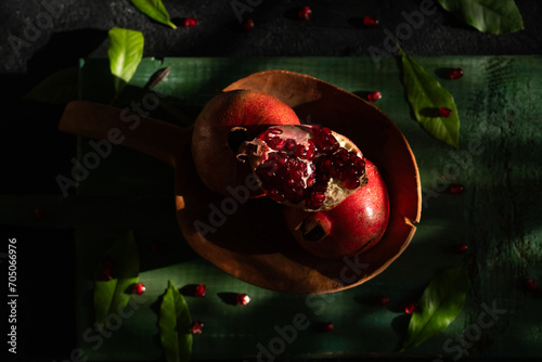 Pomegranates and Pomegranate Seeds (Nar ve Nar Taneleri) on a Wooden Background Photo, Uskudar Istanbul, Turkiye (Turkey) photo