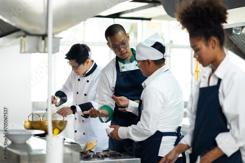 Group of student learning. Cooking class. culinary classroom. group of happy mature man and young woman multi - ethnic students are focusing on cooking lessons in a cooking school.