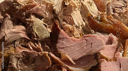 Fototapeta Naklejka Na Ścianę i Meble -  Cut pieces of roasted turkey and ham on a serving platter