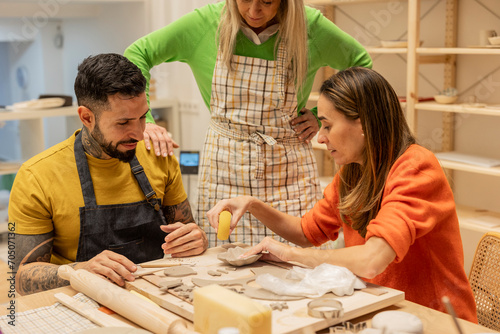 Social reintegration of a Latino man with tattoos receiving classes in a ceramic workshop with his colleagues