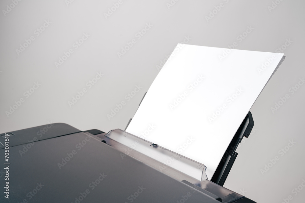 Close up of printer with loaded paper on gray background Close up of printer with loaded paper on gray background