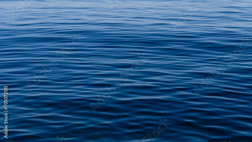 Sea Blue Ocean in Spain with soft gentle ripples on the top surface texture with summer sunlight refracting