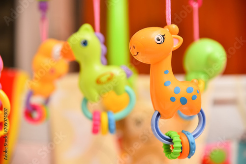 Rattles with music spinning above the baby's crib.