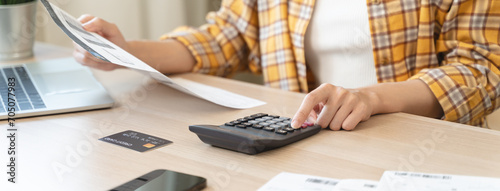 Closely Examining Financial Matters: Person's Hand Engaged in Precise Calculation of Bills Using a Calculator
