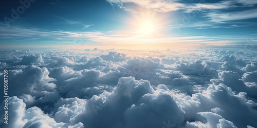 A breathtaking view above the clouds with sunlight piercing through.