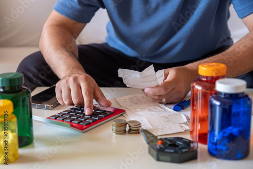 Male calculating costs of medicine while holding receipts