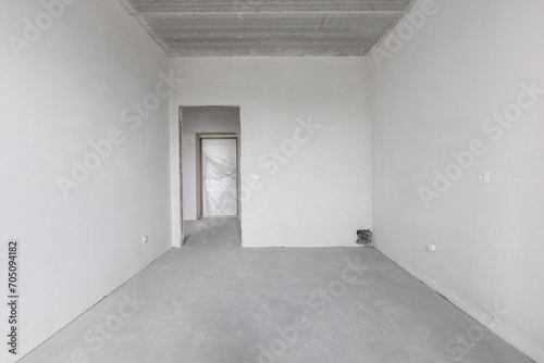 interior of the apartment without decoration in gray colors. rough finish