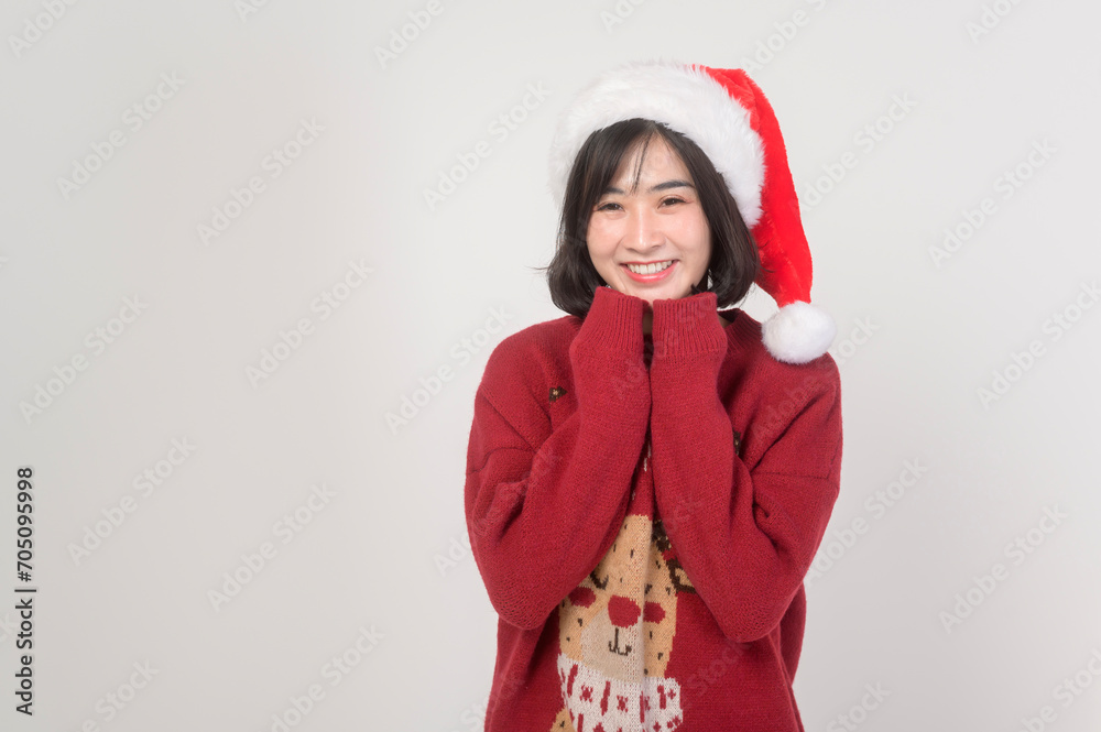 Young happy woman in santa claus hat wearing red sweater over white background, Christmas concept. Young happy woman in santa claus hat wearing red sweater over white background, Christmas concept.