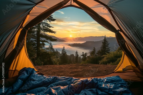 Sunrise view from inside a tent overlooking a mist covered mountain range.