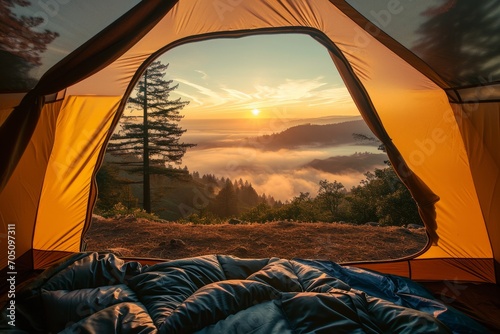Sunrise view from inside a tent overlooking a mist covered mountain range.