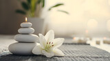 Zen Stones with Lit Candle and White Lily Flower on a Tranquil Background