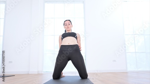 Beautiful young woman practicing yoga at home. Yoga asana.