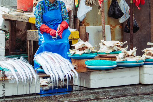 Jagalchi Fish Market in Busan, the largest seafood market in Korea. Ajumma selling beltfish in the local fresh fish market in Busan, South Korea.