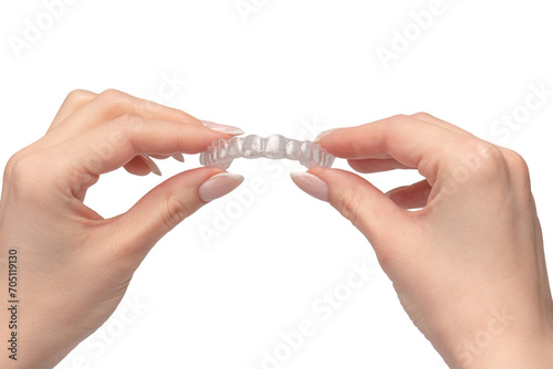 Transparent mouth guard in a woman s hand isolated.