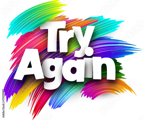 Try again paper word sign with colorful spectrum paint brush strokes over white.