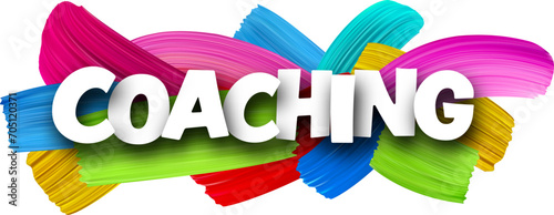 Coaching paper word sign with colorful spectrum paint brush strokes over white.