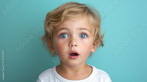 Little blond boy with beautiful blue eyes and open mouth on blue background. Generated with AI