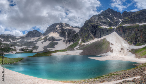 Turquoise lake among snow-capped mountains. © Sergei