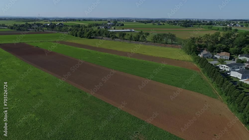 Aerial View of a Patch Work of Farmlands Next to a Mobile Home Park on a Sunny Day Aerial View of a Patch Work of Farmlands Next to a Mobile Home Park on a Sunny Day