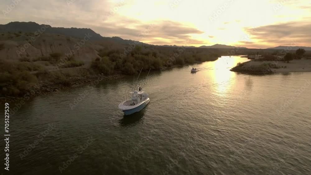 Aerial: Drone Backward Shot Of Nautical Vessels Moving In Rippled River During Sunset - Magdalena Bay, Mexico Aerial: Drone Backward Shot Of Nautical Vessels Moving In Rippled River During Sunset - Magdalena Bay, Mexico