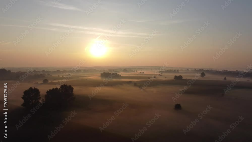 Aerial drone view of meadow landscape in The Netherlands on a sunny, foggy morning during golden hour. Misty low clouds, farmland landscape captured from above. Aerial drone view of meadow landscape in The Netherlands on a sunny, foggy morning during golden hour. Misty low clouds, farmland landscape captured from above.